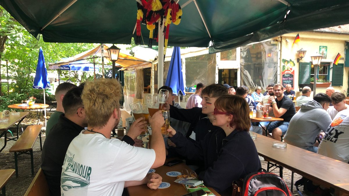 Gute Laune und Optimismus vor Anpiff am Biergarten-Tisch in München-Schwabing.