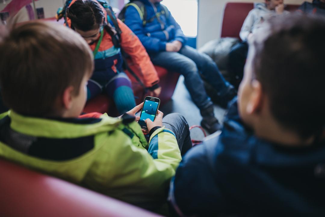 Schüler spielen am Handy.