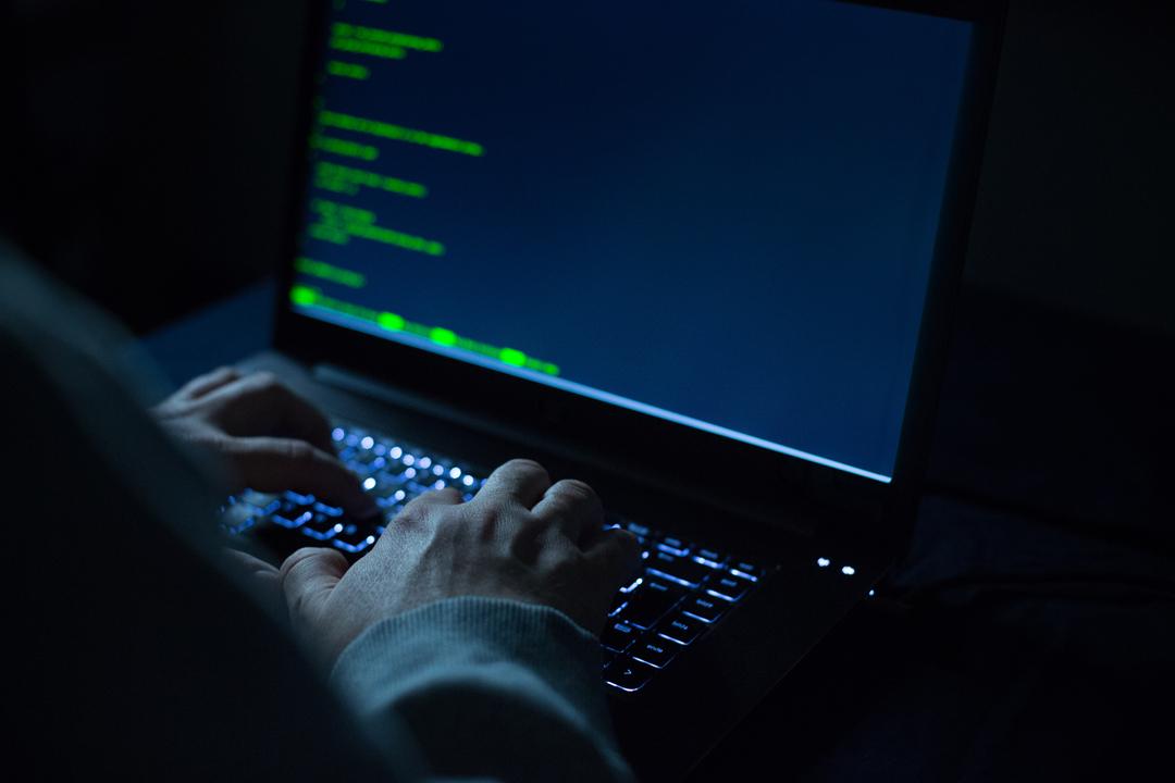 Mann sitzt an Laptop