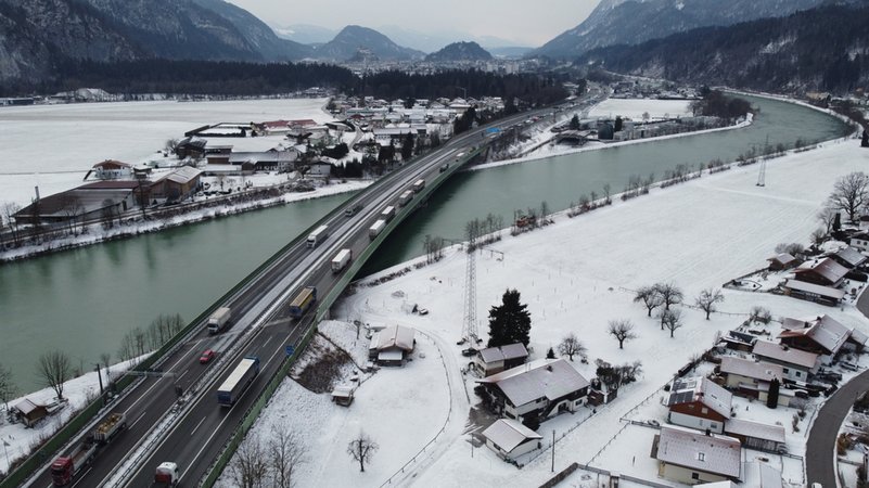 Die Lkw stauen sich auf der Autobahnbrücke über den Inn, in dessen Mitte die Grenze zwischen Deutschland und Österreich verläuft.