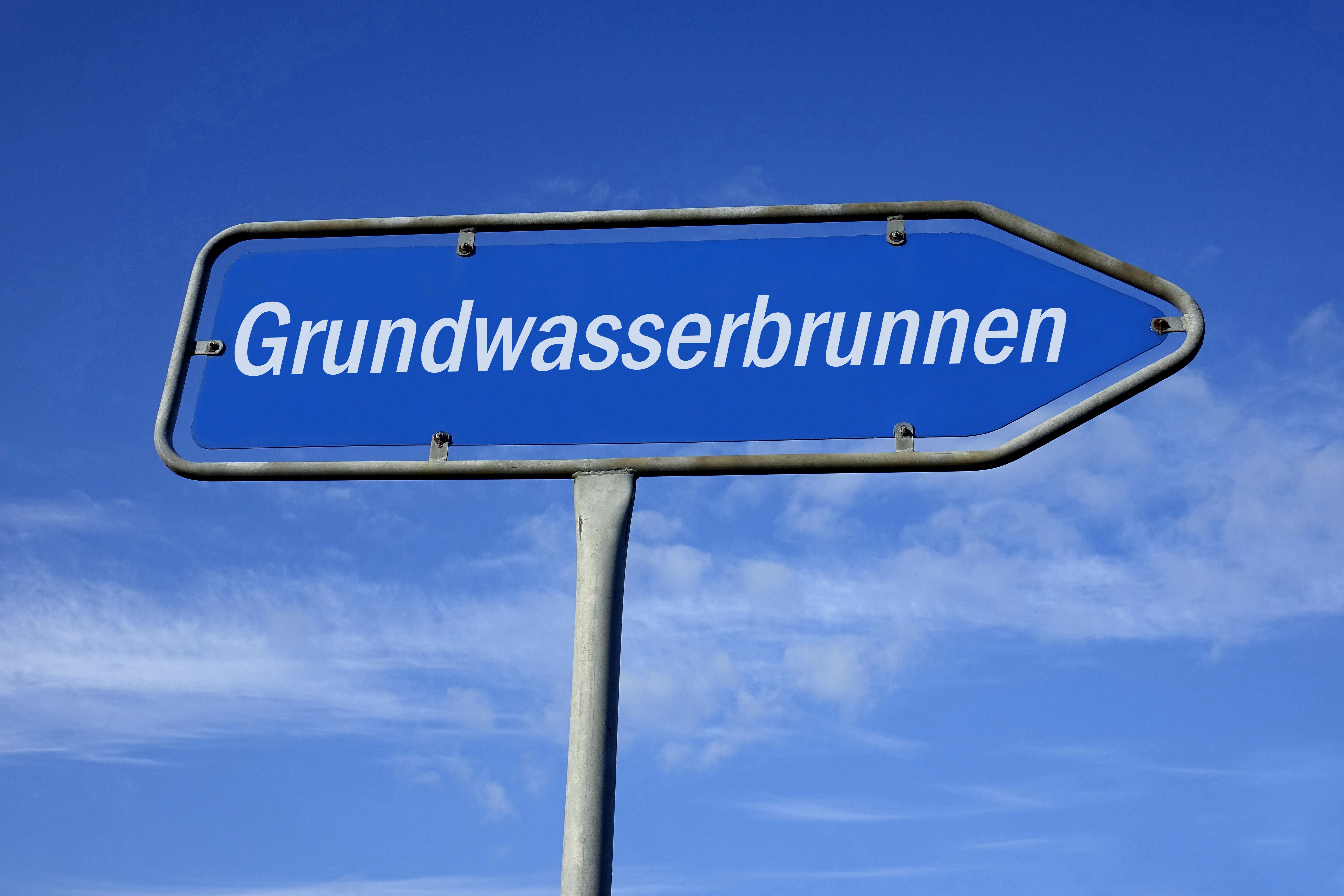 Auf einem Wegweiser befindet sich der Schriftzug Grundwasserbrunnen 