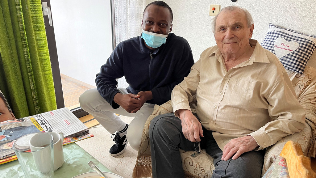 Pfleger Adam Mohamed mit einem der Senioren im Lauinger Pflegeheim. | Bild: BR/Judith Zacher Pfleger Adam Mohamed mit einem der Senioren im Lauinger Pflegeheim.