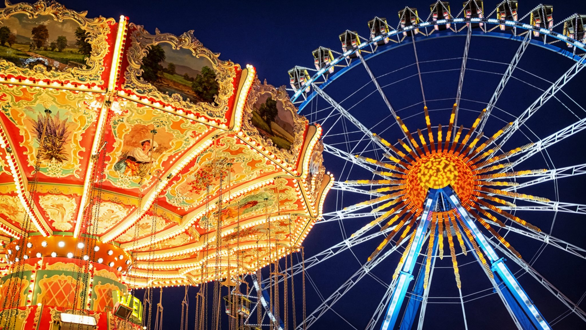 Kettenkarussell und Riesenrad auf dem Oktoberfest | Bild: dpa-Bildfunk Kettenkarussell und Riesenrad auf dem Oktoberfest