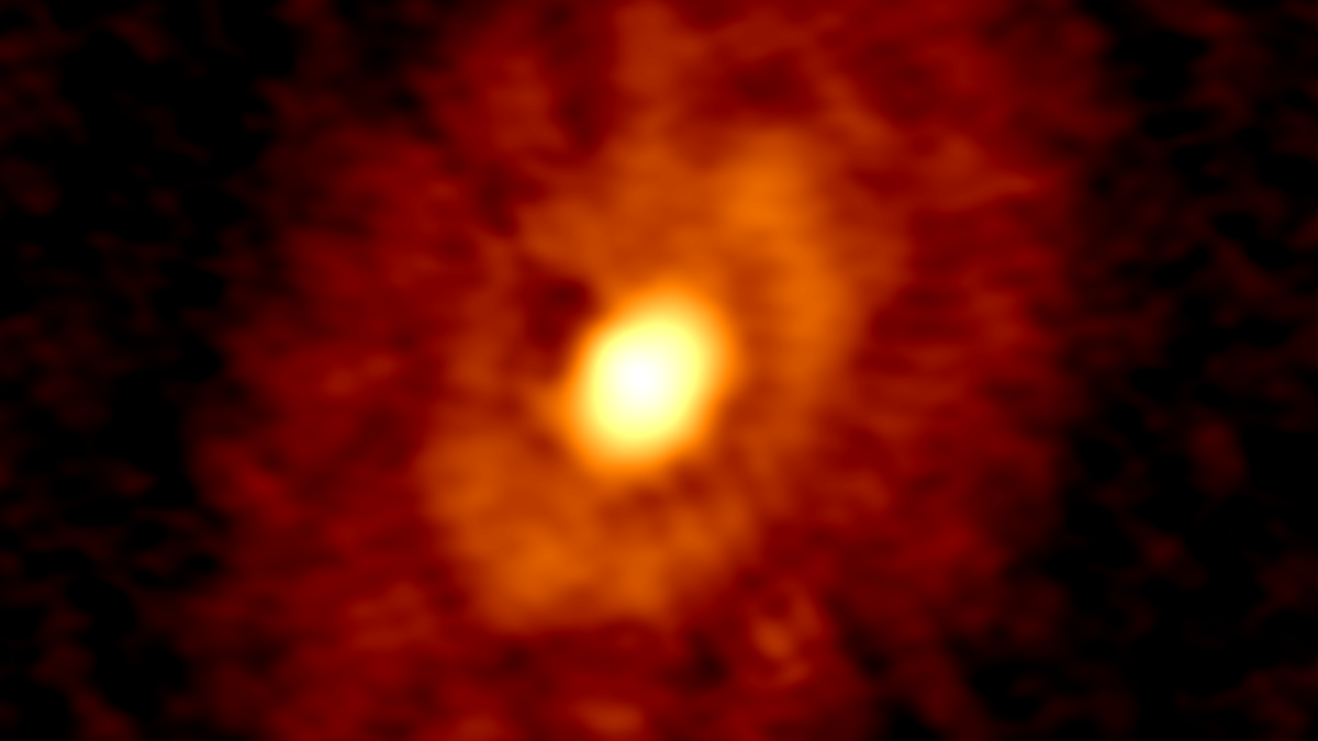 Der Bildausschnitt zeigt eine astronomische Aufnahme des jungen Sternsystems IRS 63, in dem ein junger Protostern von ringförmigen Strukturen aus Gas und Staub umgeben ist.